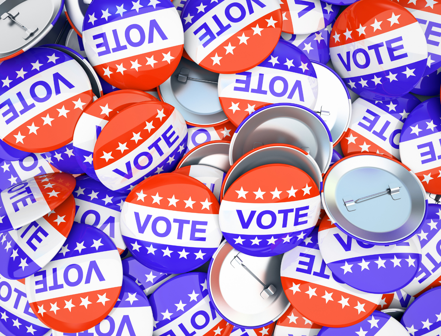 A collection of red, white and blue "vote" lapel buttons.