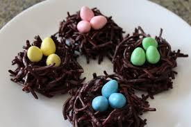 Picture of chocolate covered pretzel birds nests filled with candy eggs.