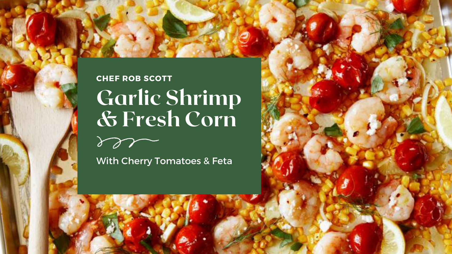 A sheet pan covered with roasted shrimp, corn and tomatoes and sprinkled with fresh herbs and feta cheese