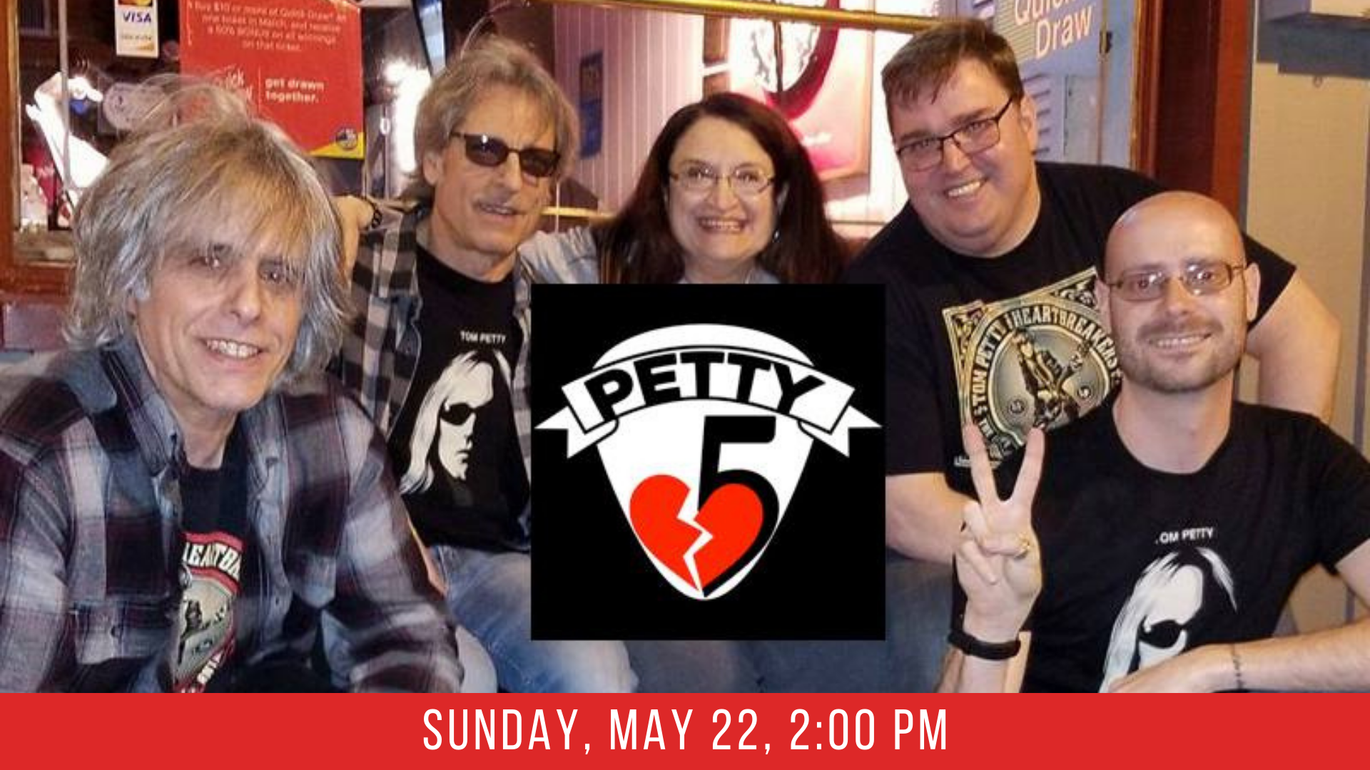 A photograph of the band Petty 5 with their logo in the foreground which consists of the number 5 with 'petty' written above it next to a broken heart.