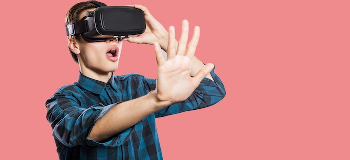Boy using virtual reality head set