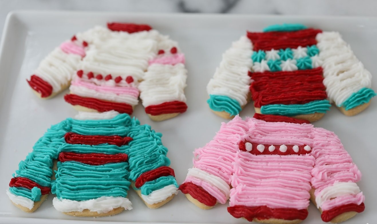 Cookies shaped and decorated like sweaters