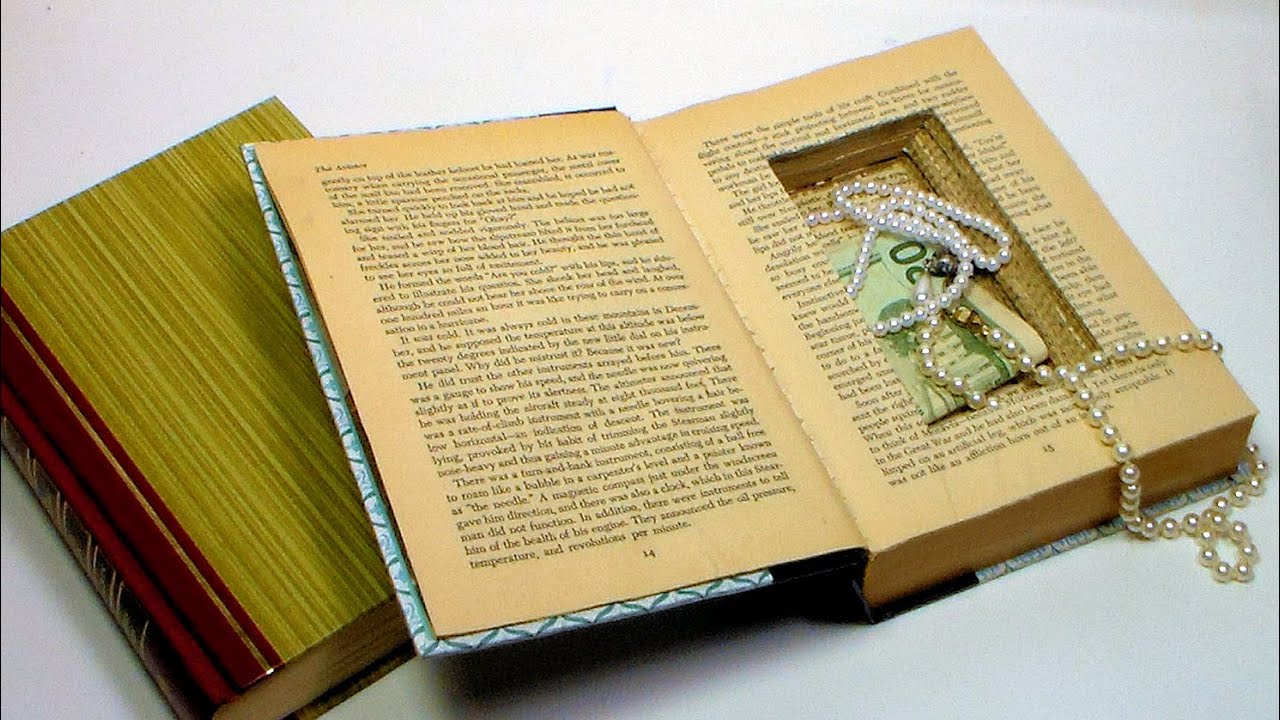 book with a hole cut out and money and jewelry hidden inside it