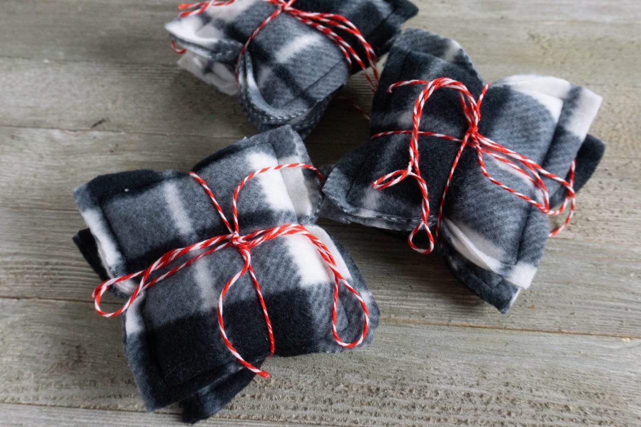 DIY 3 sets of handwarmers in black and white checkered fleece with red string tied around them