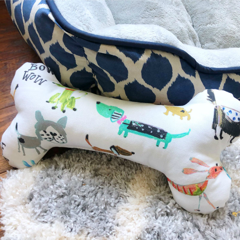 DIY Dog Bone white with dog pattern and next to a dog bed