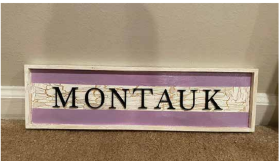 A wooden sign with 'MONTAUK' written on it.