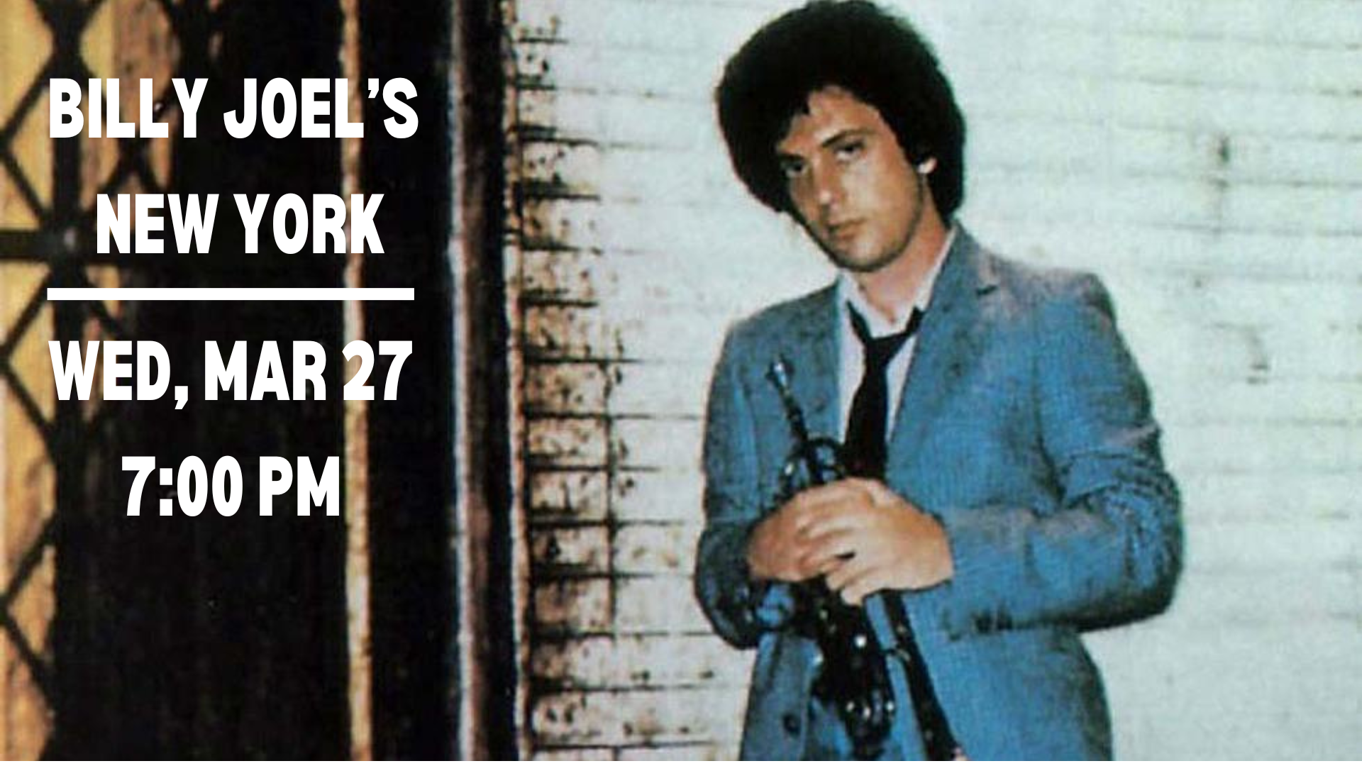 Billy Joel standing against a brick wall in 1970's New York holding a trumpet.