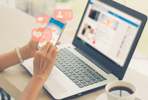 Graphic with a laptop computer and a person using their smartphone.