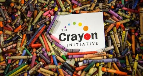 The Crayon Initiative logo with pile of crayons