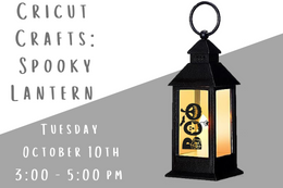 Image of a black lantern with a fake candle glowing in with with the word Boo written on the outside.