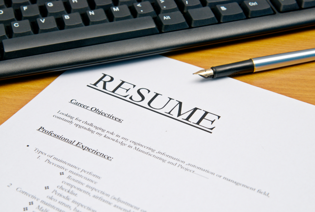 Graphic with a resume and computer keyboard.