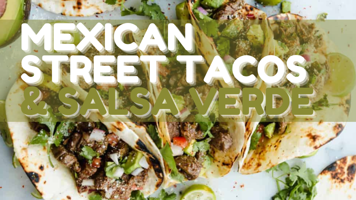 A close of up photo of street tacos on a counter with lime wedges next to them.