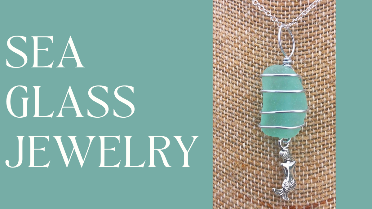 A photograph an a necklace pendant made of sea glass against a burlap background.