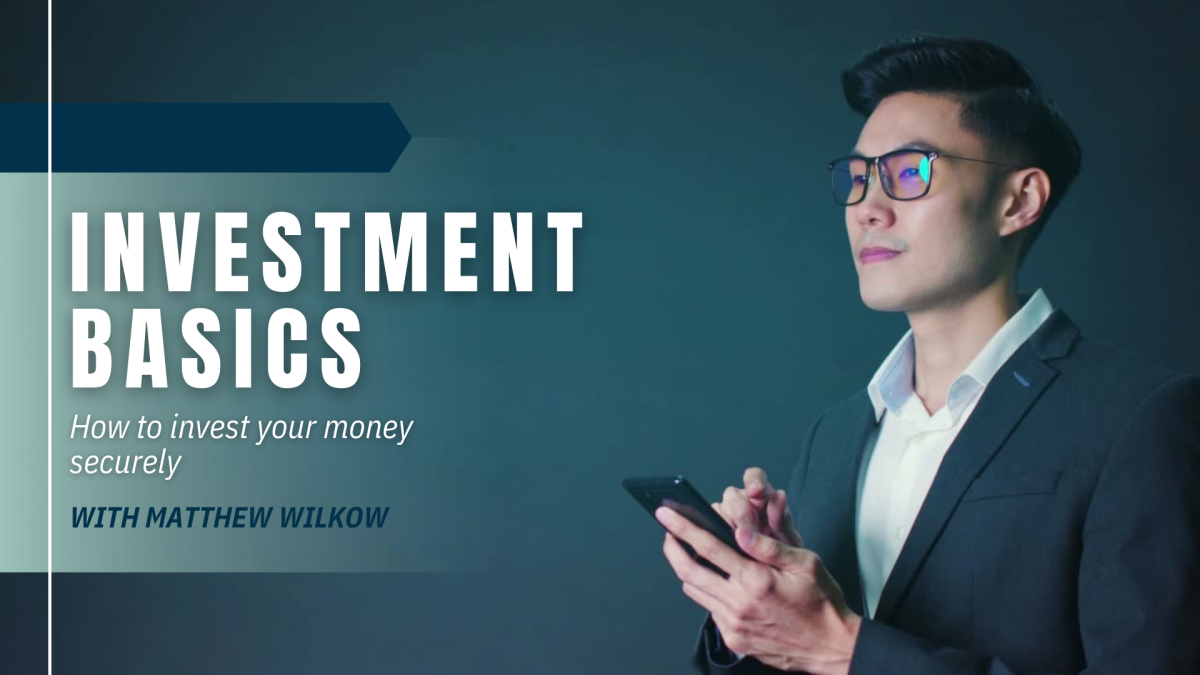 An Asian man with glasses looking at a calculator