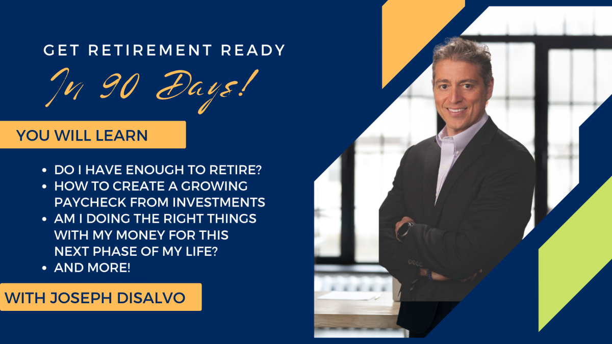 A man standing in an office with his arms folded.