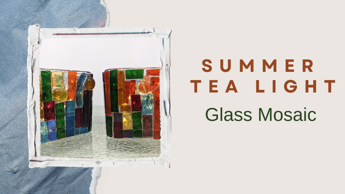 Two glass mosaic tea light holders on a table.