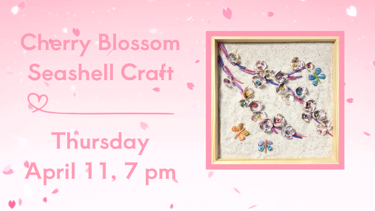 A cherry blossom branch made of seashells on sand.